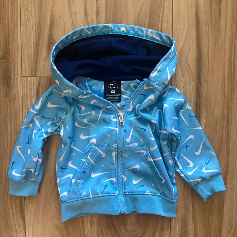 Nike Light Blue Zip-Up Hoodie with Swoosh Pattern Size 12 Months